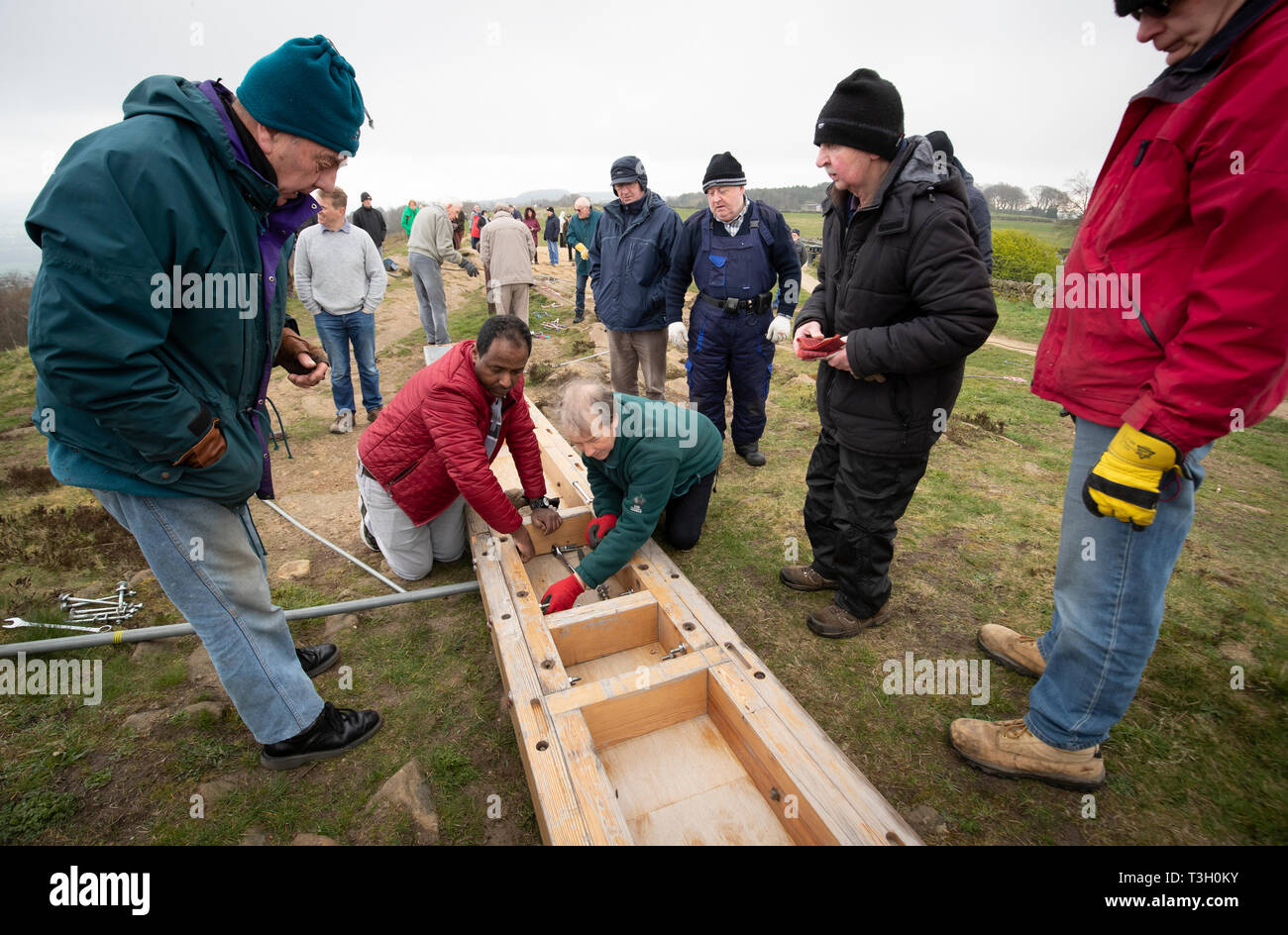 Oltre 50 persone installare un 36-piedi alto cross prima di Pasqua a sorpresa vista dalla cima di Otley Chevin nello Yorkshire. Foto Stock