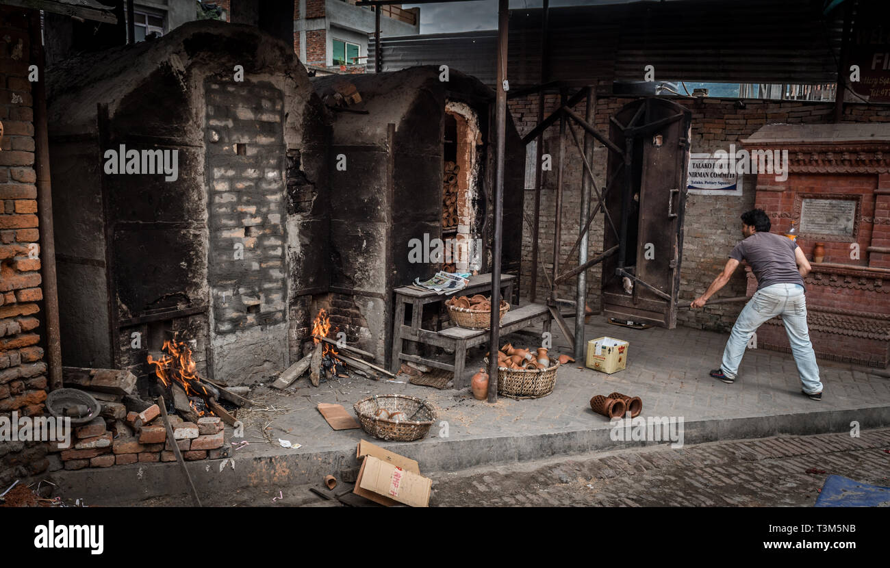 Gli uomini la cottura in ceramica in un forno Bhaktapur, Nepal Foto Stock