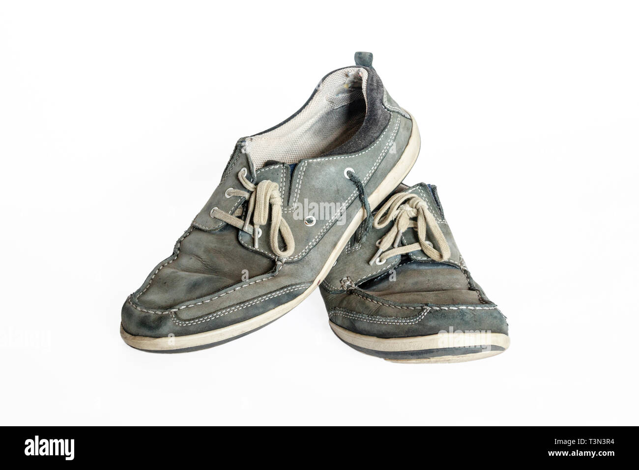 Close-up di coppia di vecchi usurati blu-grigio pelle scamosciata scarpe con lacci isolata contro uno sfondo bianco Foto Stock