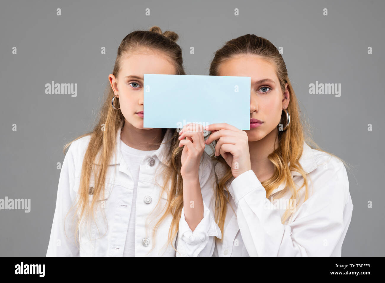 Appello di buona cercando simile ragazze in abiti bianchi che porta targa dati trasparente Foto Stock