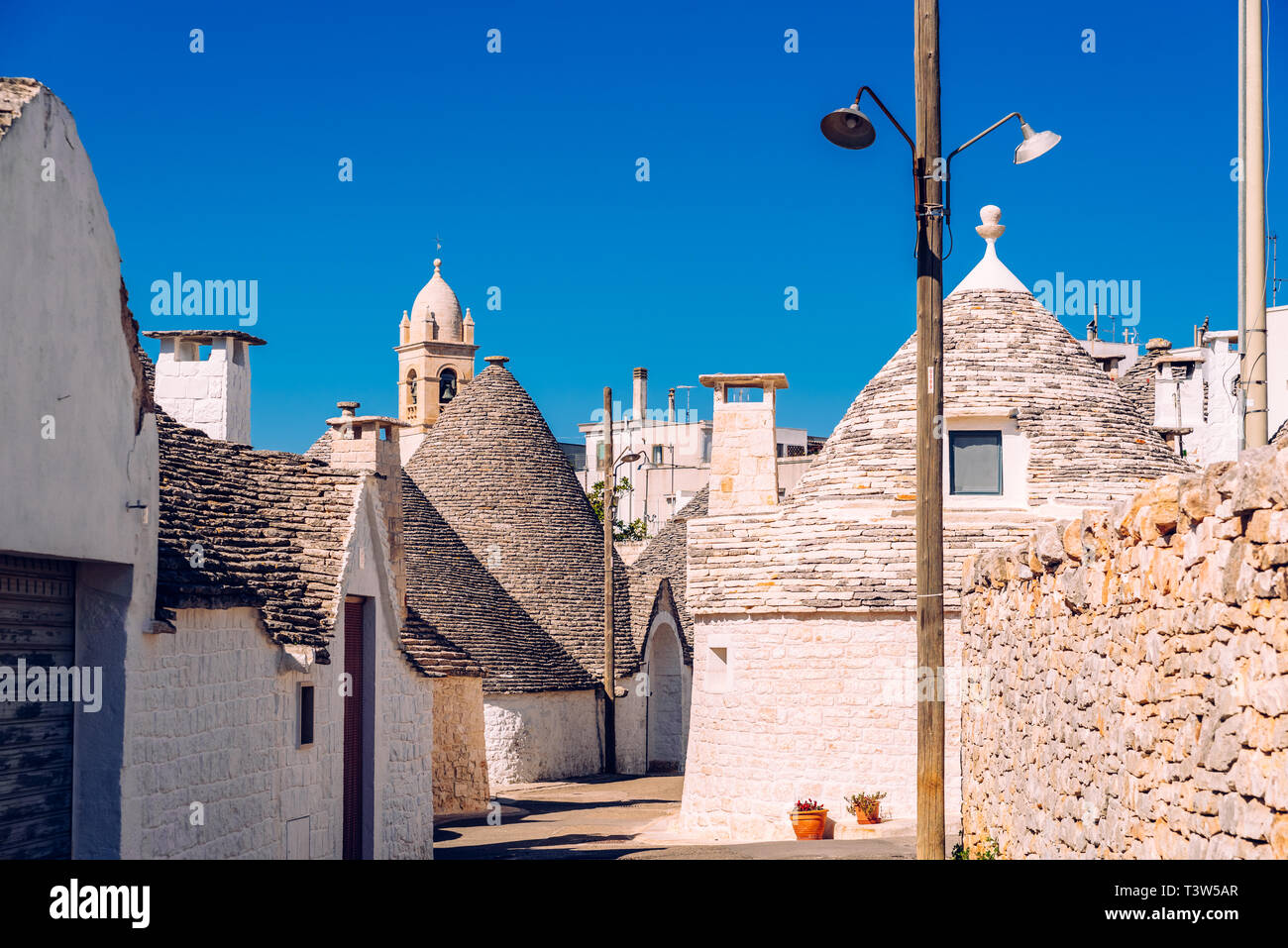 Strade strette tra i trulli di Alberobello, nel sud Italia, ideale per i viaggi in famiglia. Foto Stock