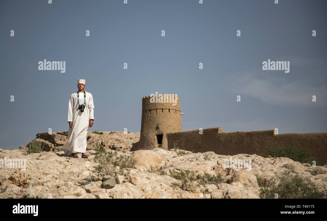 Al Sulaif, Oman, 9 Aprile 2016: omani uomo a fotografare le rovine di Al castello Sulaif Foto Stock