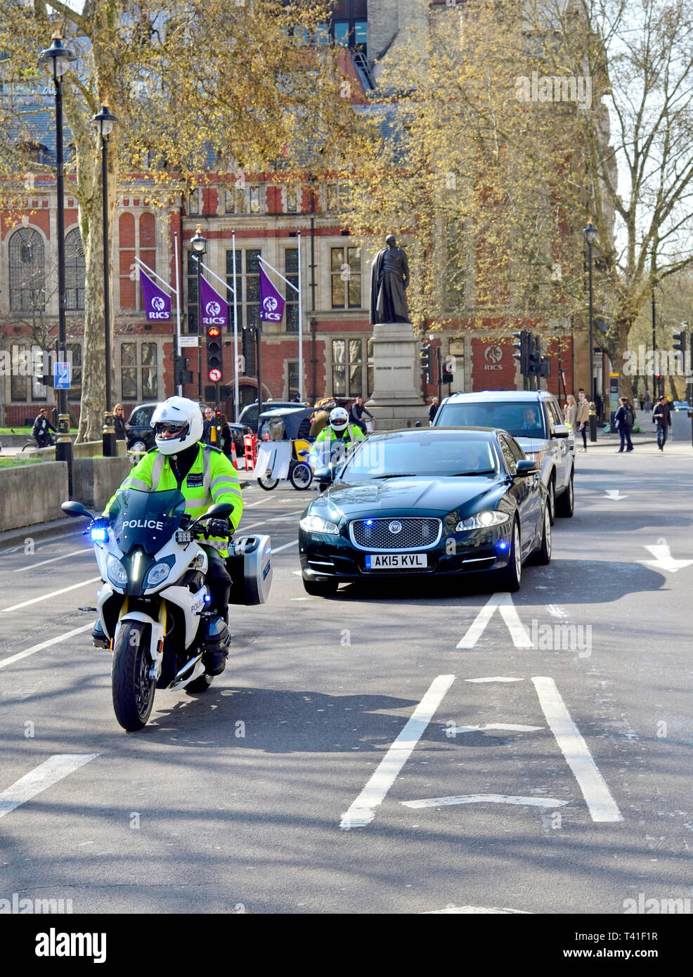 Londra, Inghilterra, Regno Unito. Il Primo Ministro automobili e motorcylce outriders guidando attraverso la piazza del Parlamento Foto Stock
