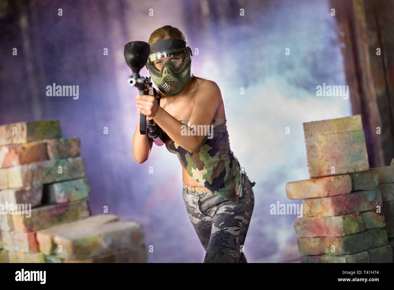 Femmina attraente paintball player con la pistola Foto Stock