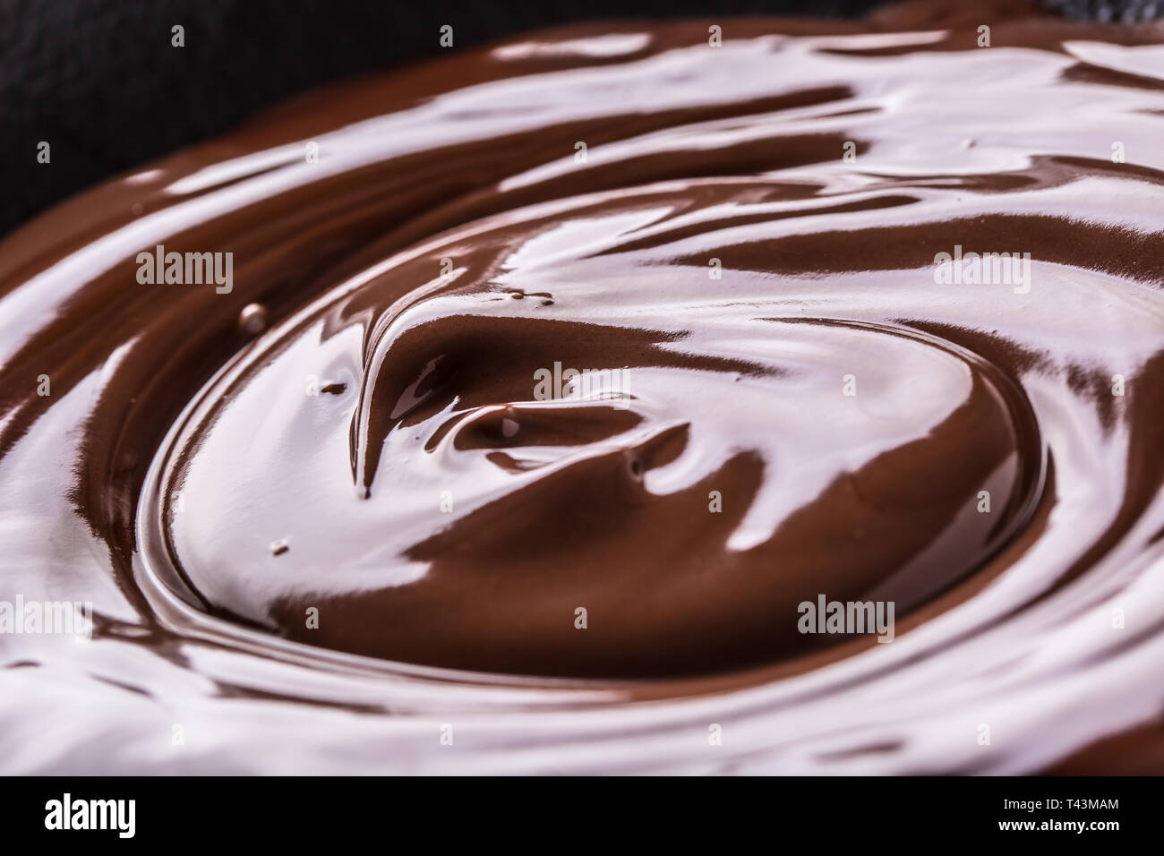 Close-up scuro fuso o il cioccolato al latte di sfondo di turbolenza. Foto Stock