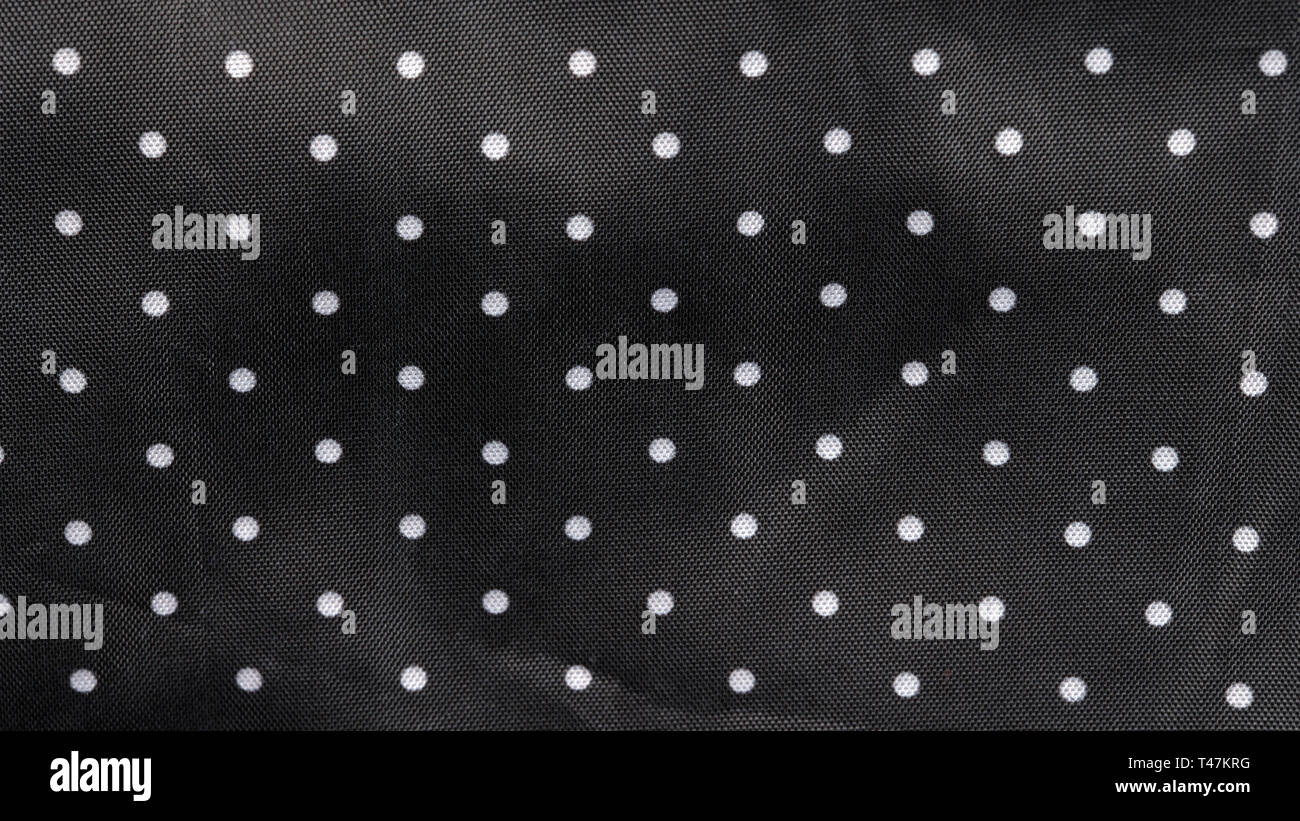Tessuto nero lo sfondo con puntini bianchi Foto Stock