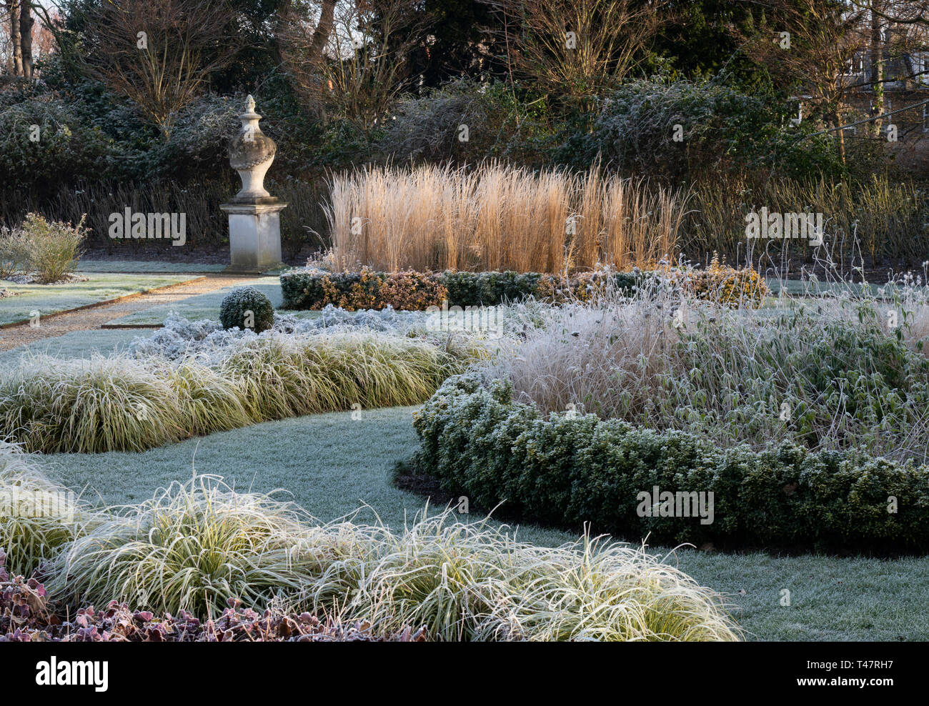 Frost rivestito di piante e una urna di pietra nel giardino all'italiana a Chiswick House, Chiswick, London, Regno Unito Foto Stock