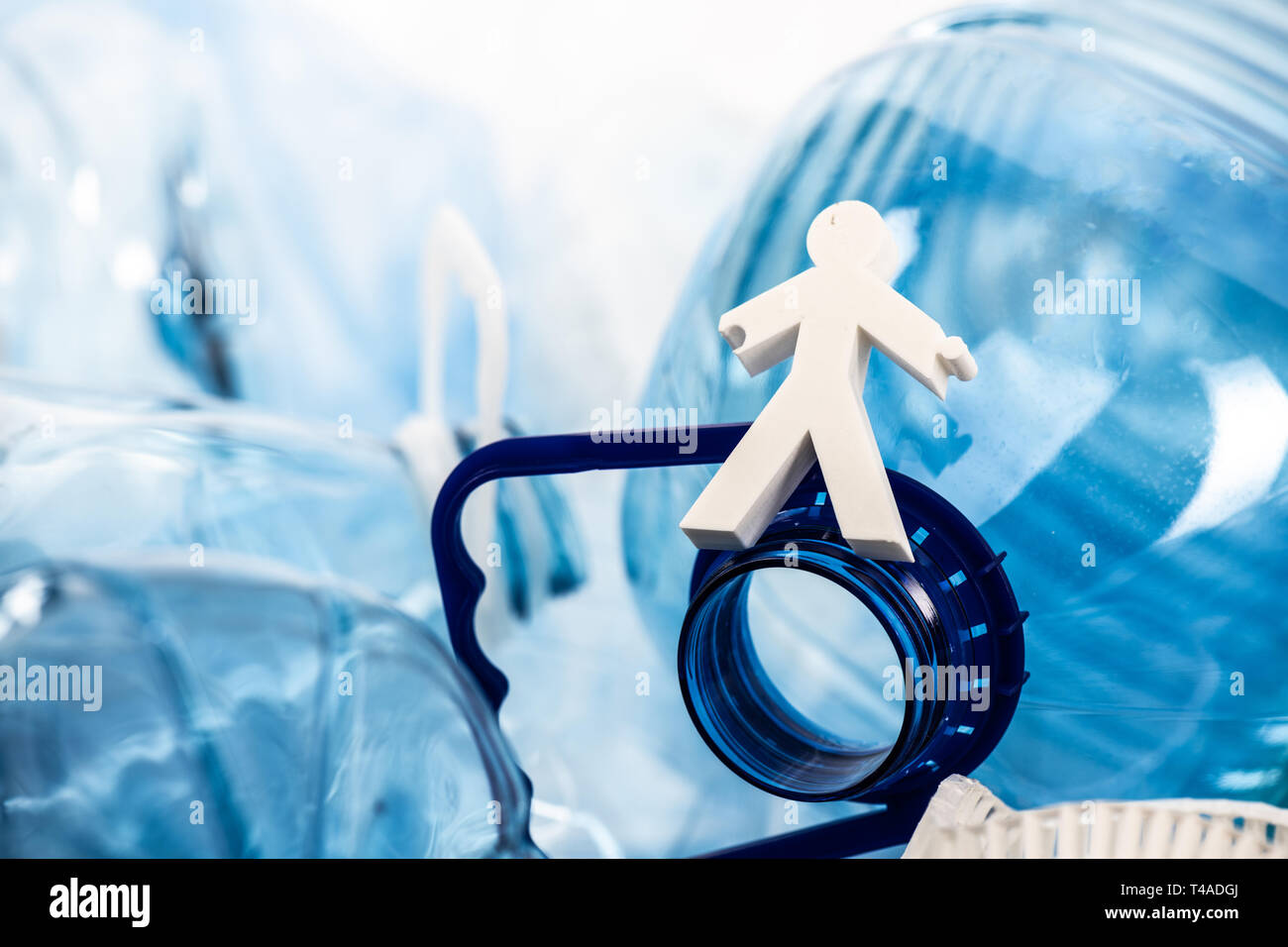 Di piccole dimensioni e di colore bianco la figura della persona che soggiorna sul collo della bottiglia di plastica Foto Stock