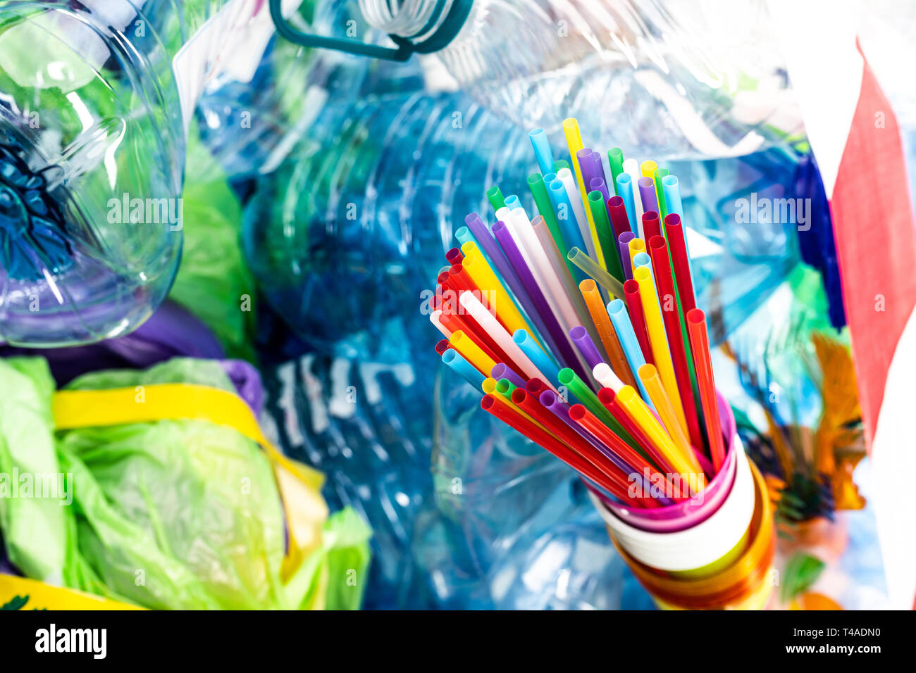 Luminose colorate cannucce soggiornando in plastica tazza monouso Foto Stock