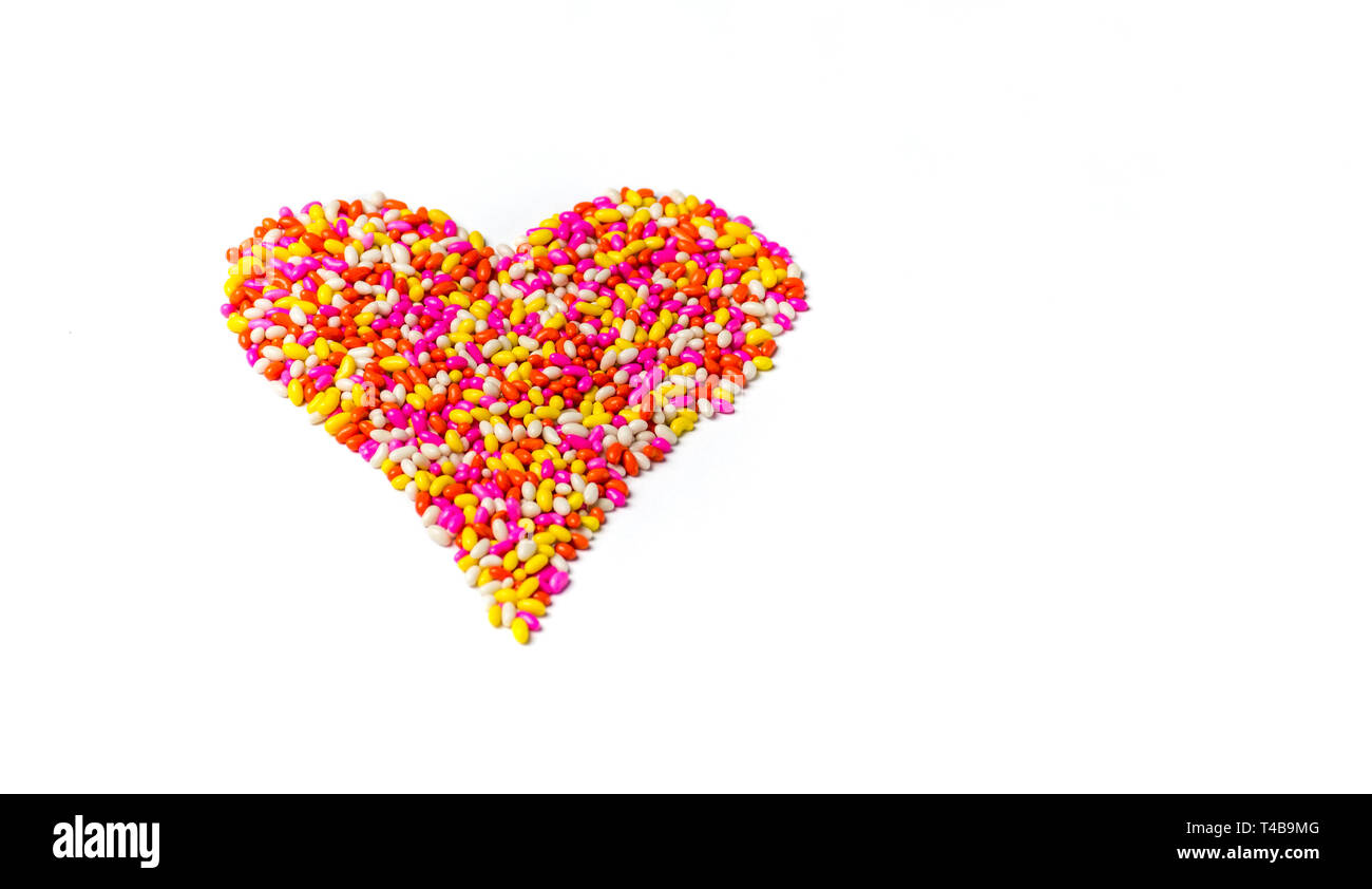 Coloratissima caramella dolce forma di cuore sfondo multicolore modello di cioccolato isolato con sfondo bianco colorato sfondo HD Foto Stock