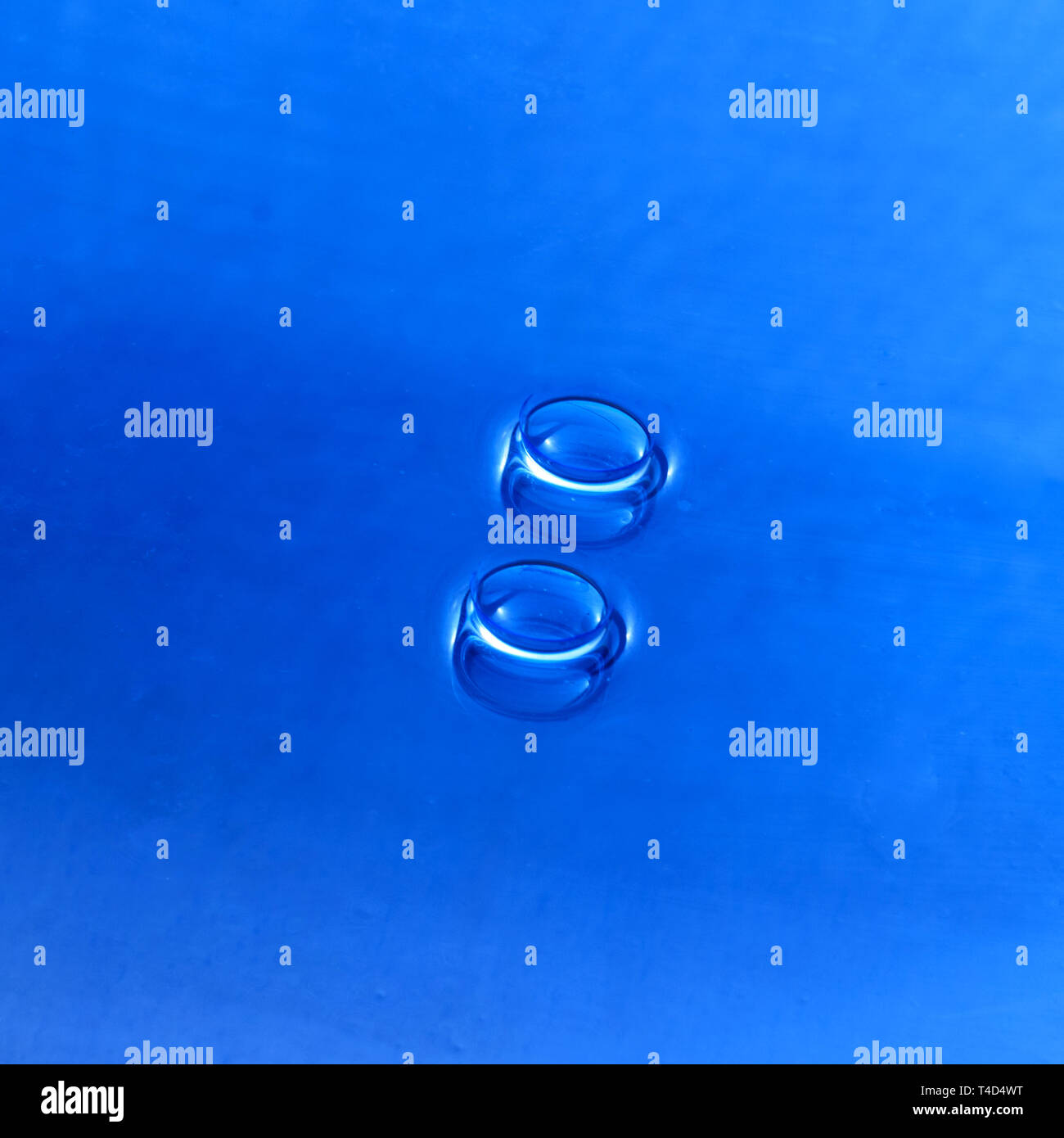 Due lenti a contatto su viola scuro sfondo.cornice quadrata. Foto Stock