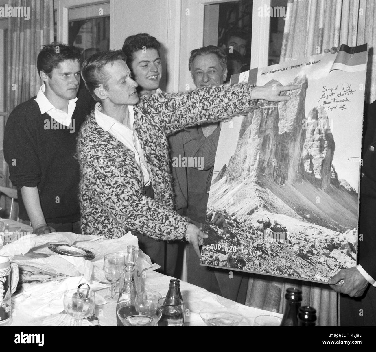 I tre alpinisti che hanno restituito dalla montagna 'Drei Zinnen', chiamato anche Tre Cime di Lavaredo, il 26 di Gennaio di 1963, spiegare le difficoltà che gli alpinisti hanno di fronte durante la salita sulla scogliera settentrionale della montagna. La foto mostra Peter Siegert, puntando sull'immagine a sinistra il fratello Horst Siegert, dietro di lui Rainer Kauschke e un uomo che non è stato individuato (r). (Archivio foto dal 27 gennaio nel 1963). | Utilizzo di tutto il mondo Foto Stock