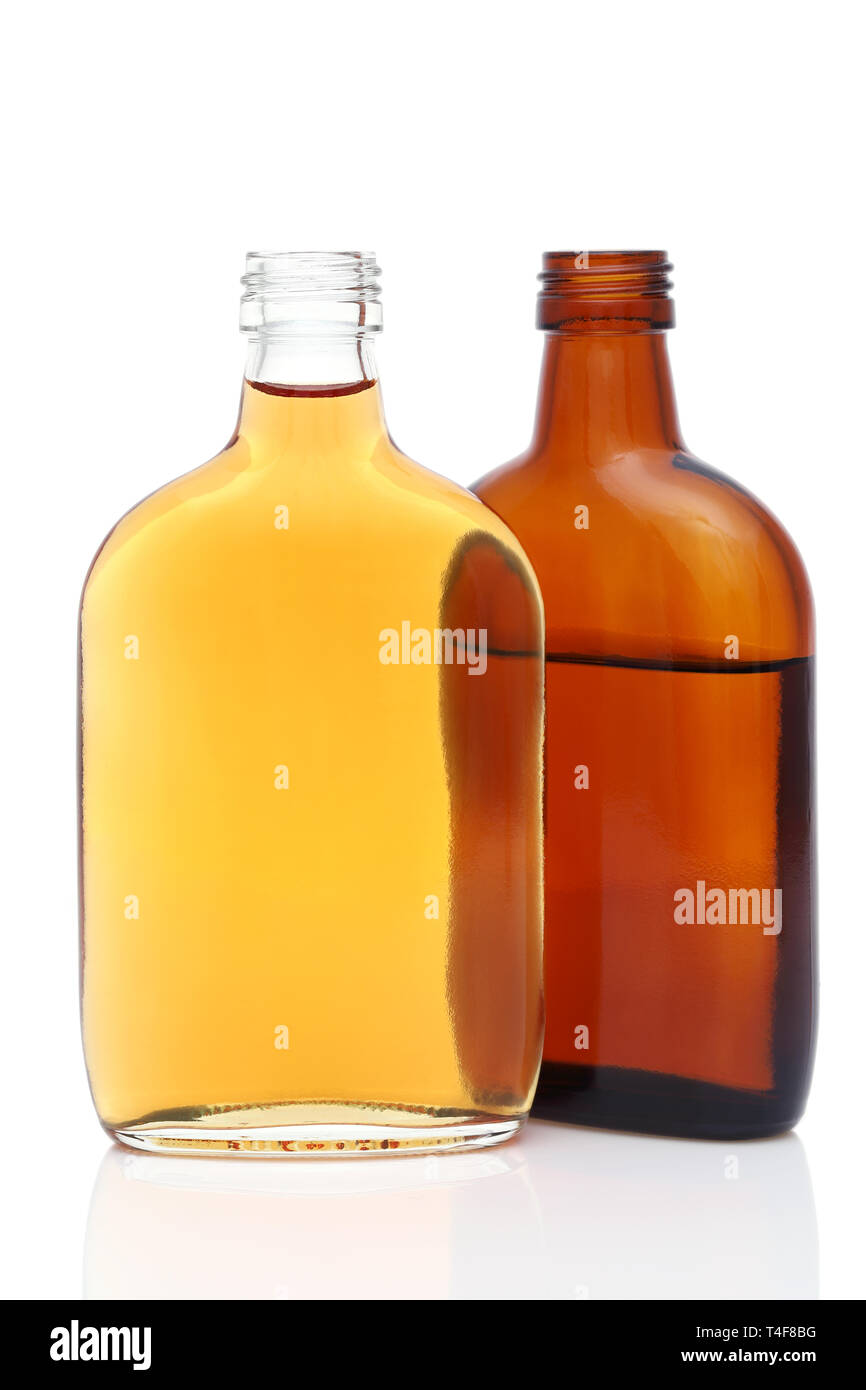 Bicchiere di vetro e una bottiglia di whiskey su sfondo bianco Foto Stock