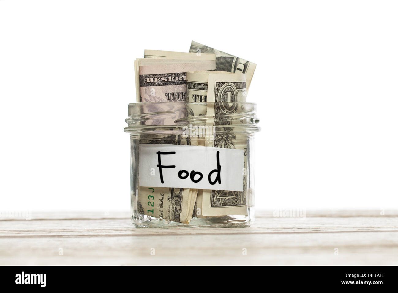 Il vasetto di vetro con il denaro per i prodotti alimentari Foto Stock