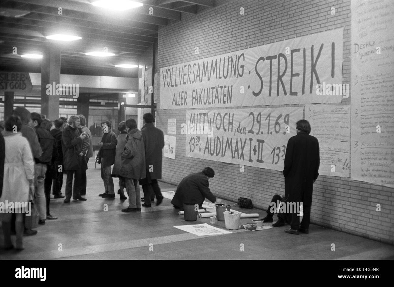 Gli studenti discutono davanti un banner dicendo "Assemblea Generale di tutte le facoltà: Strike!" presso l'Università di Amburgo il 29 gennaio 1969. | Utilizzo di tutto il mondo Foto Stock