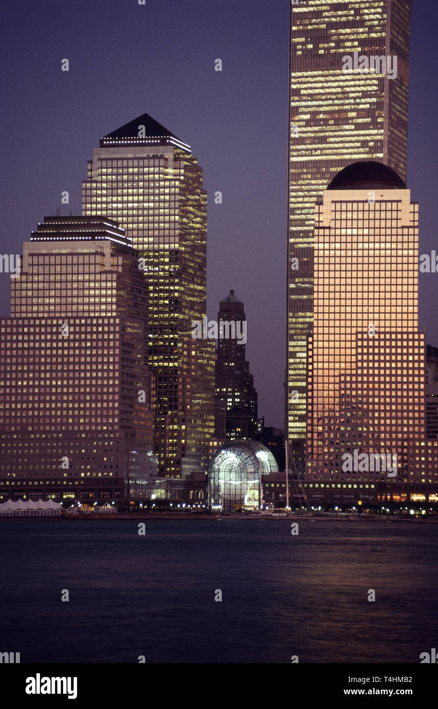 1989 foto d'epoca del Giardino d'inverno nel centro finanziario mondiale e il World Trade Center attraverso il Fiume Hudson al crepuscolo, NYC Foto Stock