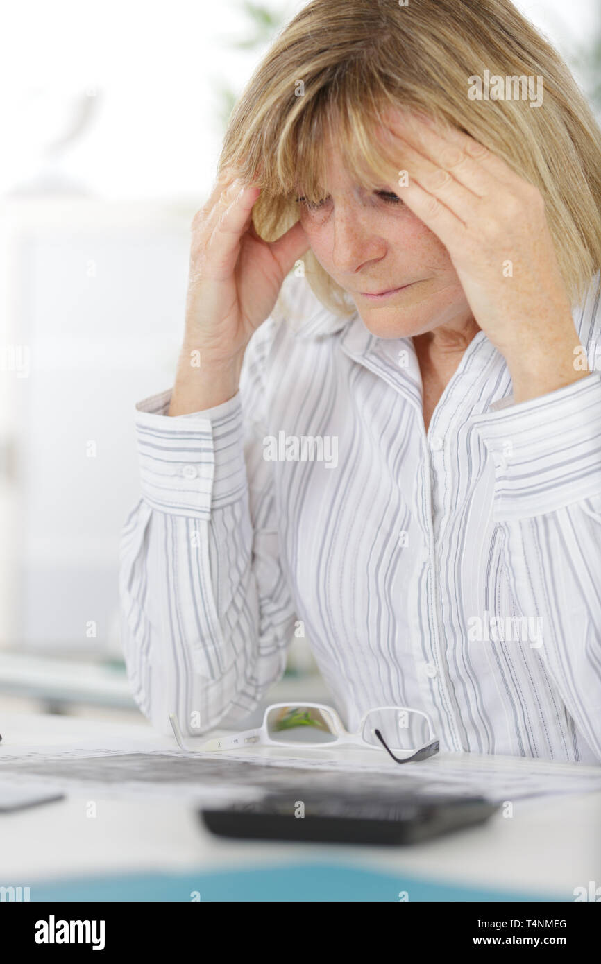 Imprenditrice che soffrono di mal di testa seduto in ufficio Foto Stock
