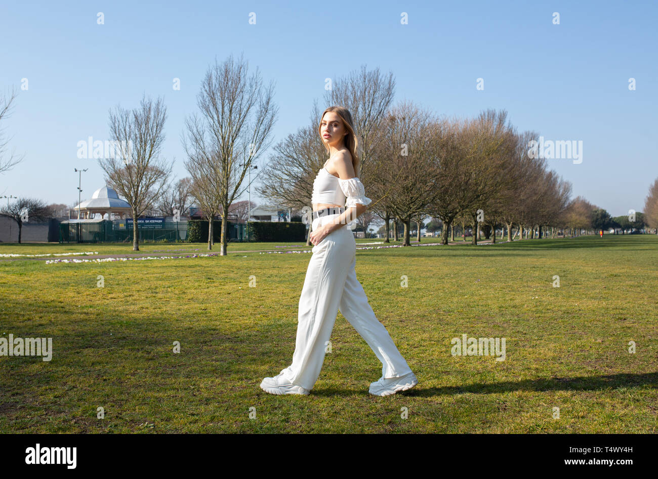 L'adolescente di sesso femminile passeggiate nel parco cercando di fotocamera Foto Stock