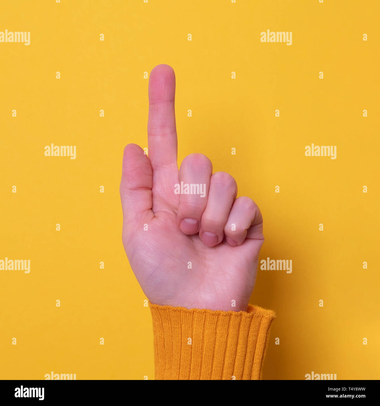 Bella donna lato rivolto verso l'alto con il suo dito indice giallo su sfondo lucido Foto Stock