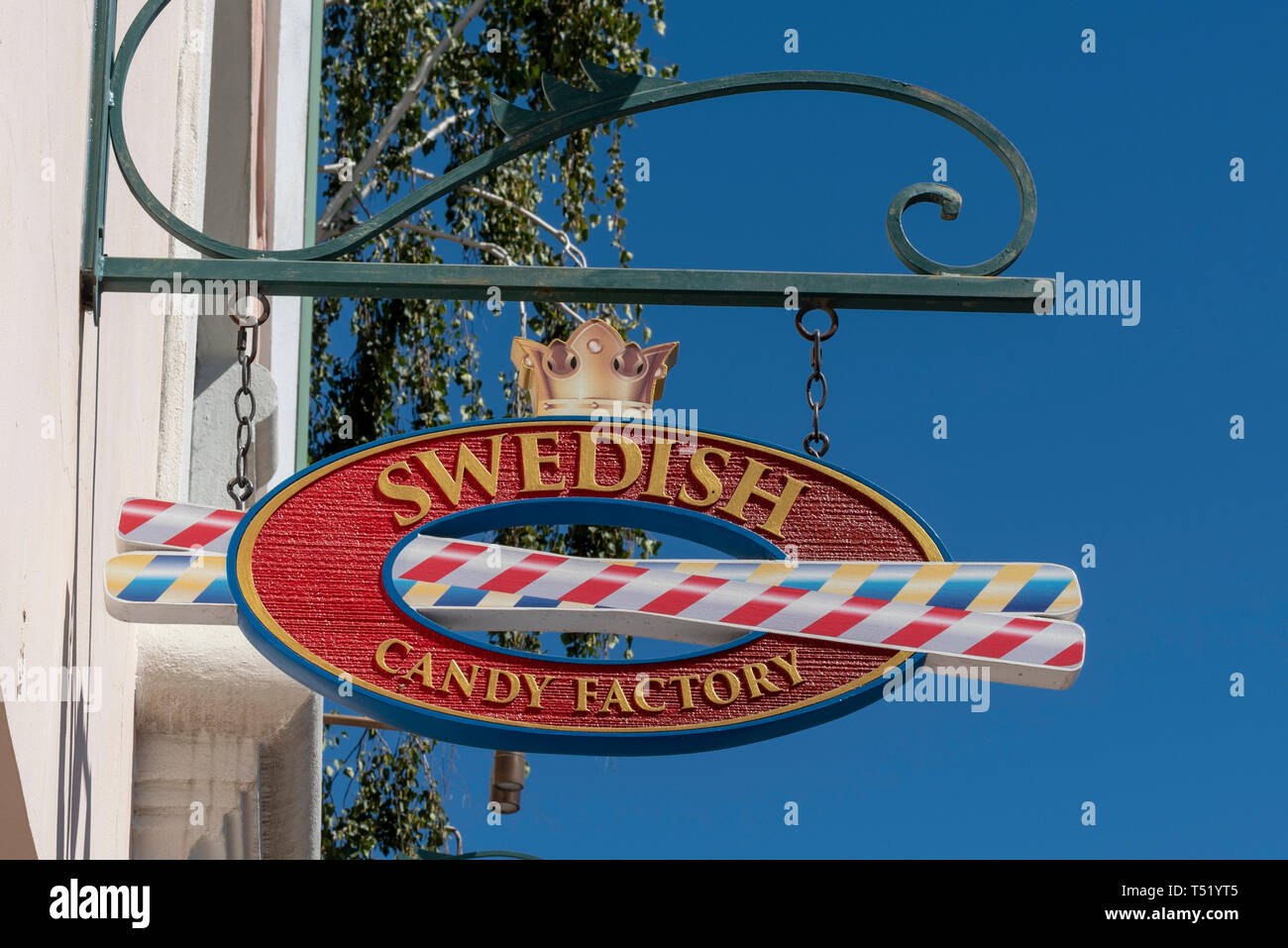 Colorato in rosso, blu, bianco e oro segno ovale con due cannucce passando attraverso il centro dell'ovale e una corona d'oro sulla parte superiore si blocca sul lato dell'edificio. Foto Stock