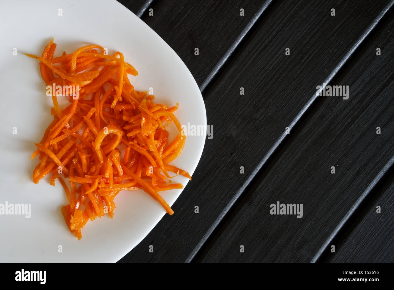 Carote marinato con spezie in una piastra bianca. Esotica cucina sovietica. Foto Stock