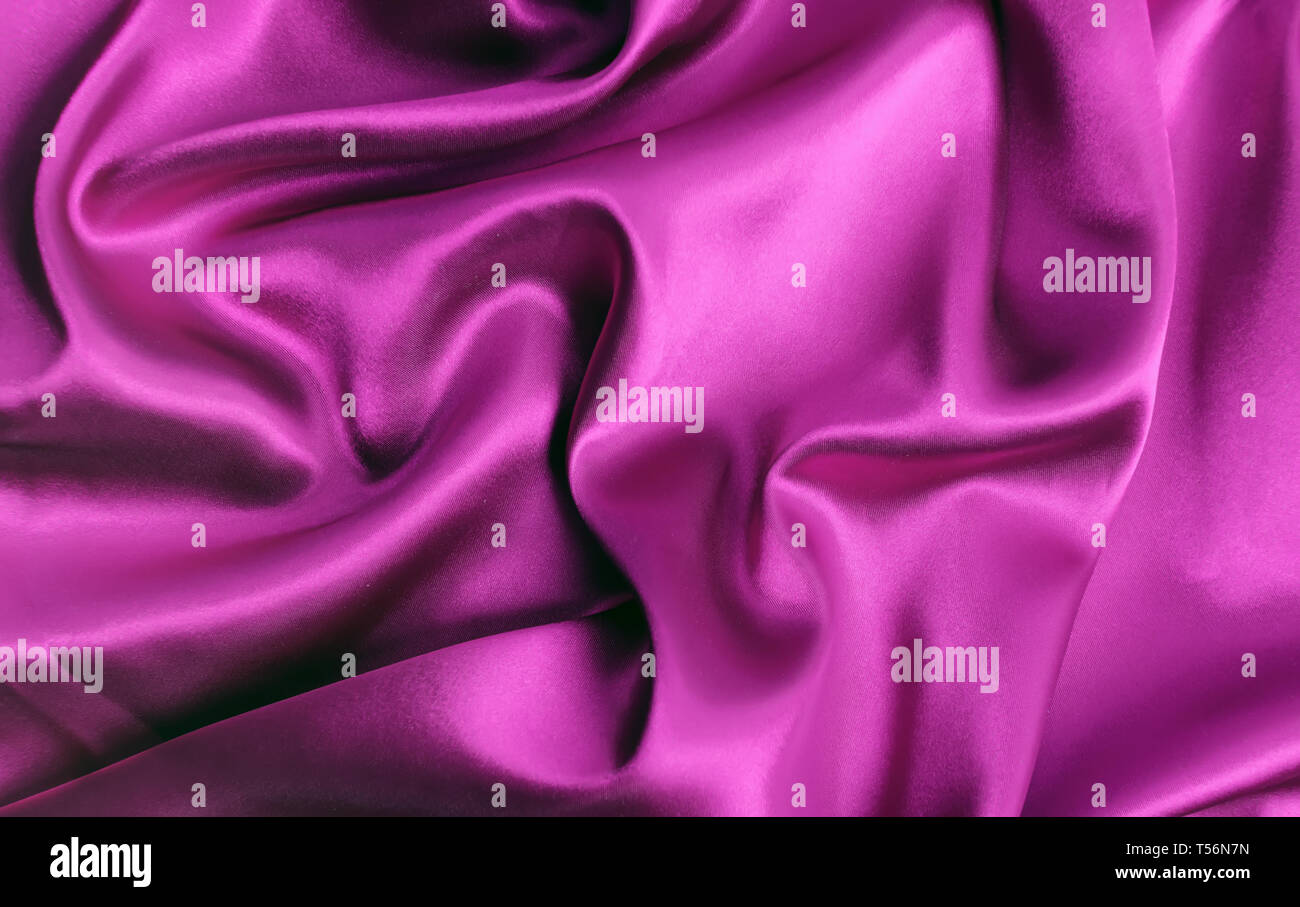 Liscia rosa elegante tessuto di seta o di raso panno di lusso la texture può utilizzare come sfondo astratto Foto Stock