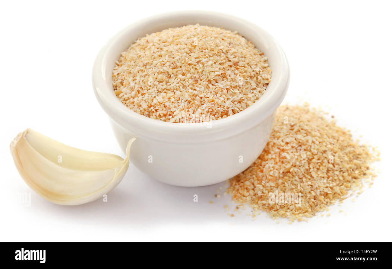 Aglio in polvere con tutto il bulbo aglio su bianco Foto Stock