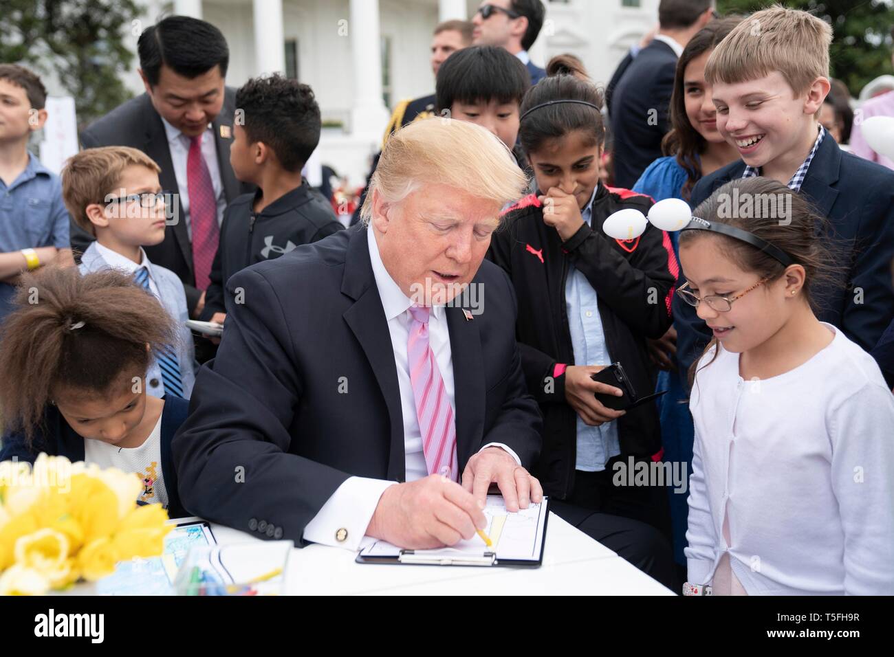 U.S presidente Donald Trump unisce i bambini ad una tabella di colorazione durante il White House Easter Egg Roll evento sul prato Sud della Casa Bianca Aprile 22, 2019 a Washington, DC. Questa è la 141anno per le relazioni annuali di primavera evento. Foto Stock