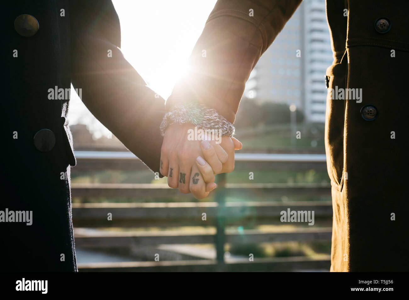 Close-up del giovane holding hands in controluce Foto Stock