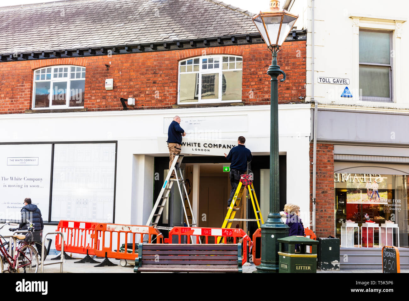 Mettendo su White Company shop segno, nuovo high street store, high street shop apertura, negozi, apertura nuovo negozio, negozio, negozio di nuova apertura, high street, Foto Stock