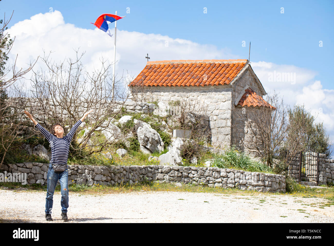 Ragazzo visita piccola cappella - Chiesa Ortodossa Serba santuario. Architettura sacrale - Ljesevici / Montenegro. Foto Stock