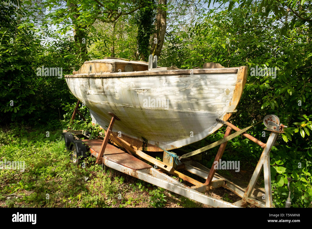 Vecchio weathered ricoperta di barca in un giardino, Cornwall, Inghilterra Foto Stock
