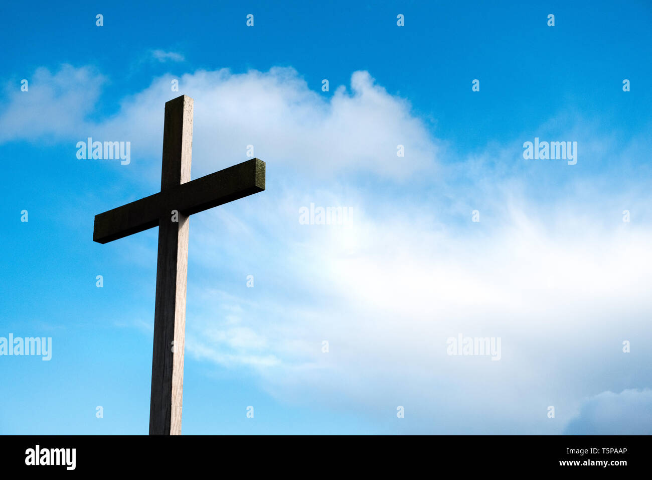 Una croce cristiana contro un cielo blu Foto Stock