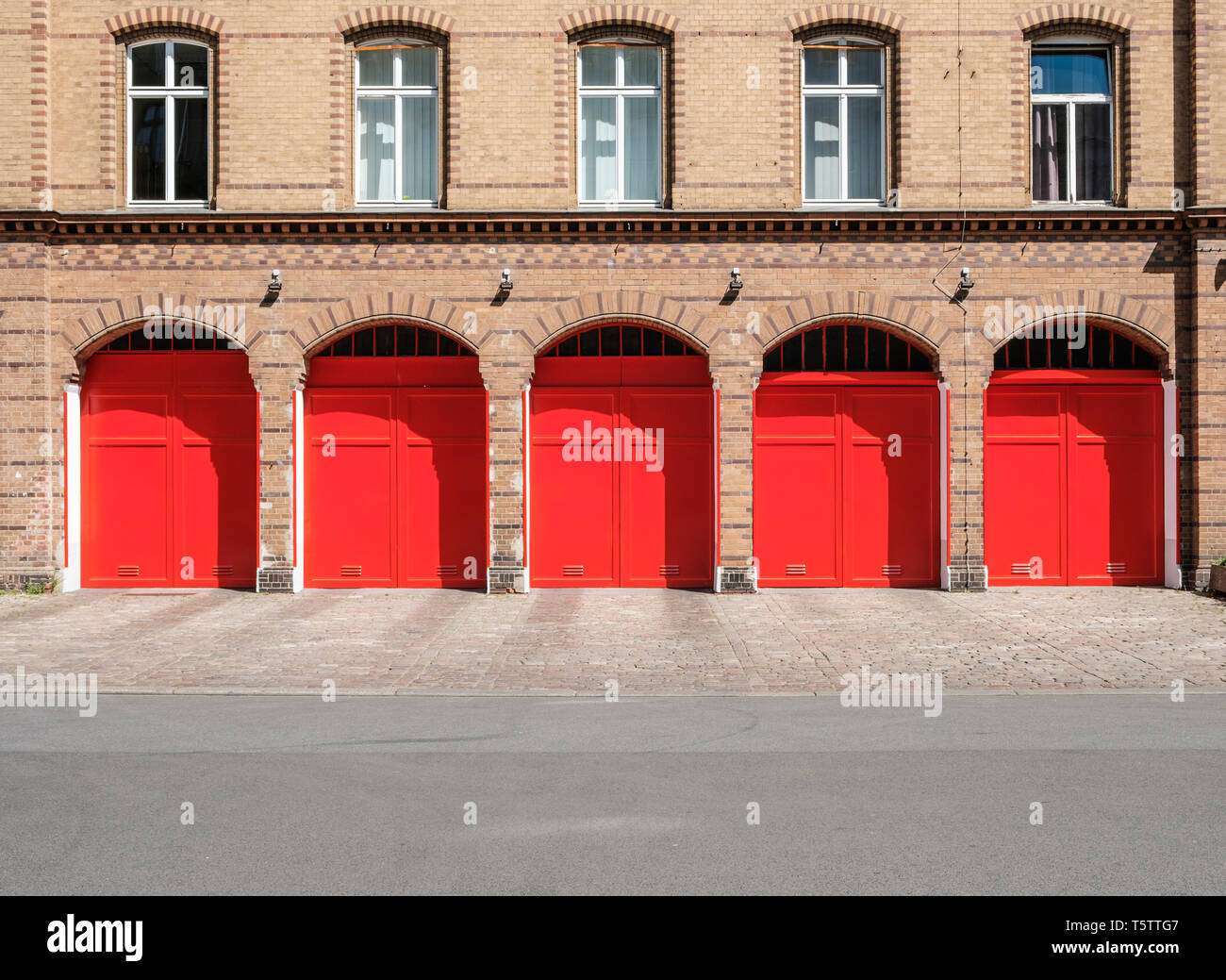 Vigili del fuoco builidng facciata con le porte sono rosse e vuoto street Foto Stock