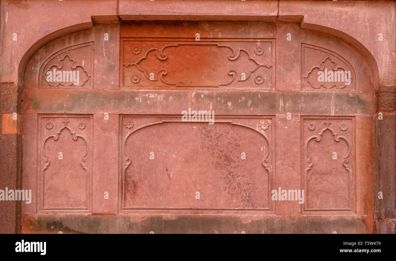 Dettaglio delle intricate sculture di pietra arenaria rossa pannelli con decorazione in rilievo all'interno delle pareti dell'Lahori Gate del Red Fort di Delhi India Foto Stock