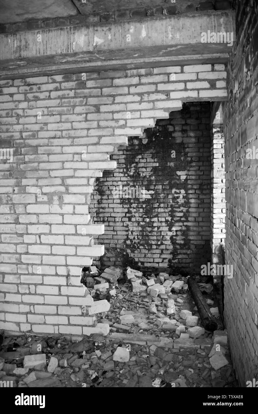 Le rovine di una casa distrutta. Edificio abbandonato. Tempo di guerra. Foto in bianco e nero Foto Stock