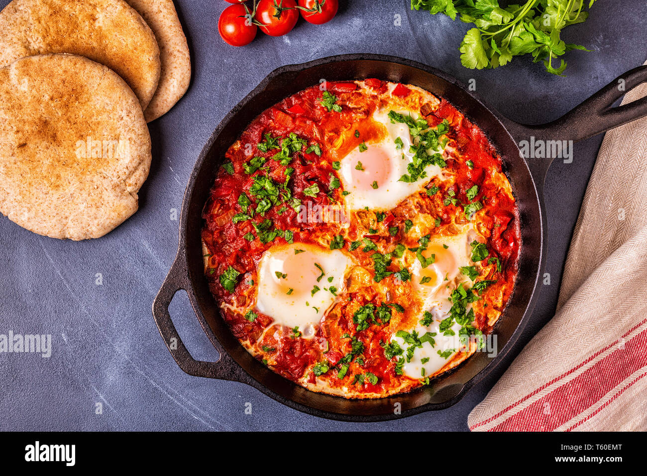 Shakshuka in una padella. Le uova in camicia in pomodoro piccante salsa di pepe. Foto Stock