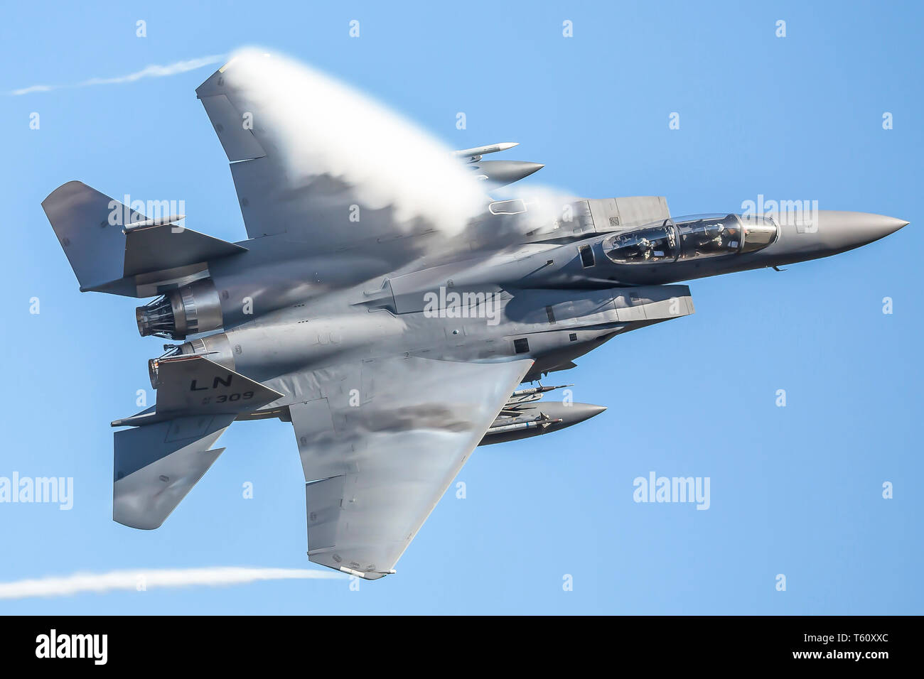 Spettacolare close up del USAF ad alta velocità F-15 velivoli militari nella formazione del Regno Unito volo, equipaggio visibile nel pozzetto, con cielo blu chiaro dello sfondo. Foto Stock