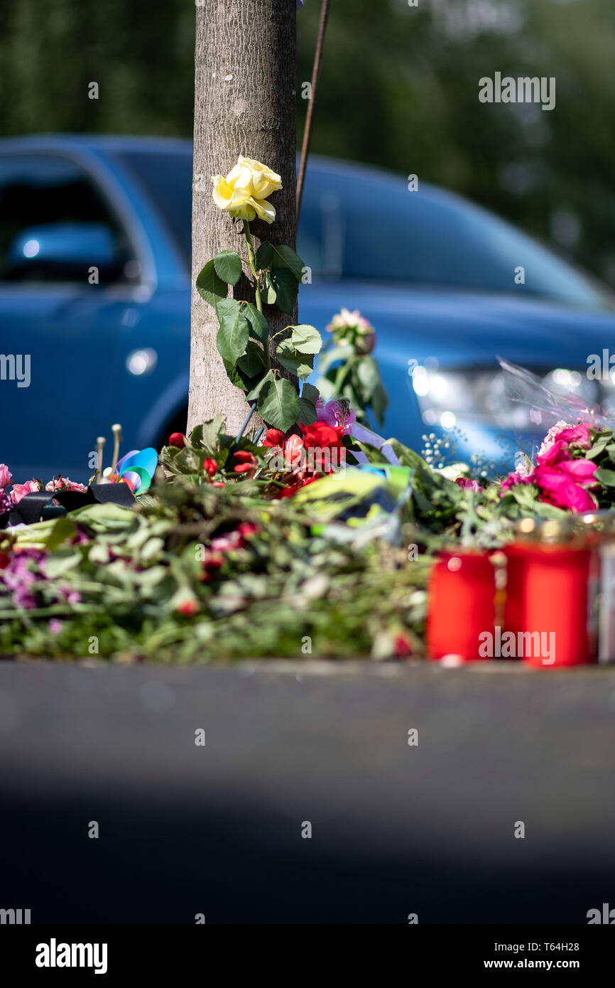 Moers, Germania. 29 apr, 2019. Fiori e candele sono in piedi nel posto dove una donna in disparte è stato ferito in un presunto car race e morirono più tardi. Due piloti sono detti avere combattuto illegalmente una vettura da gara in cavalli-strong vetture su strada a due corsie. Un driver entra in collisione con la piccola vettura della 43-anno-vecchio vittima. Credito: Marius Becker/dpa/Alamy Live News Foto Stock