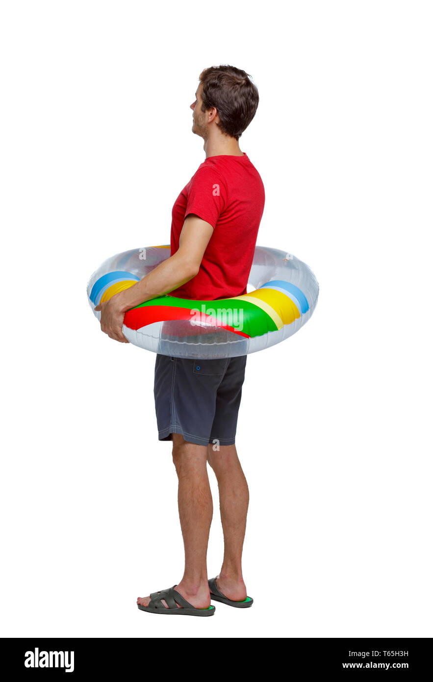 Vista posteriore di un uomo in pantaloncini corti con un cerchio gonfiabile. Il ragazzo sulla spiaggia. Vista posteriore di raccolta persone. vista posteriore di persona. Isolate su wh Foto Stock