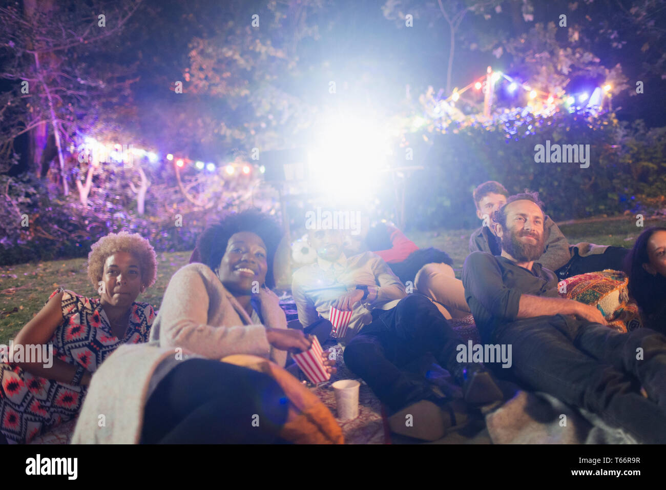 Happy amici godendo di filmato in cortile Foto Stock