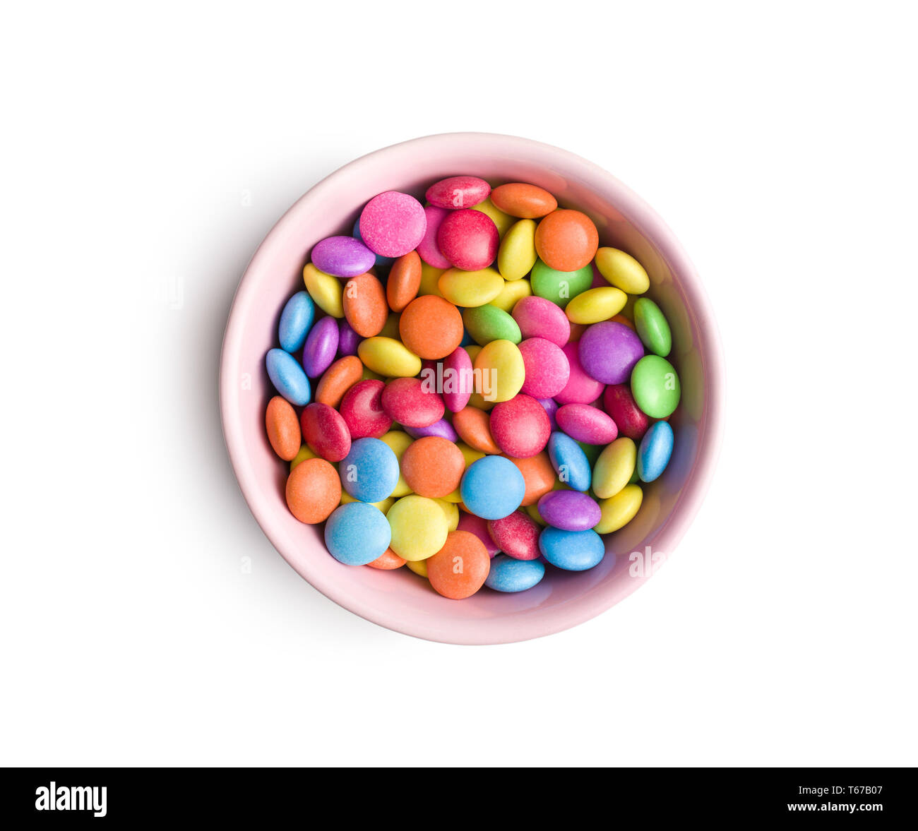Cioccolato colorato candy pillole nel recipiente isolato su sfondo bianco. Foto Stock