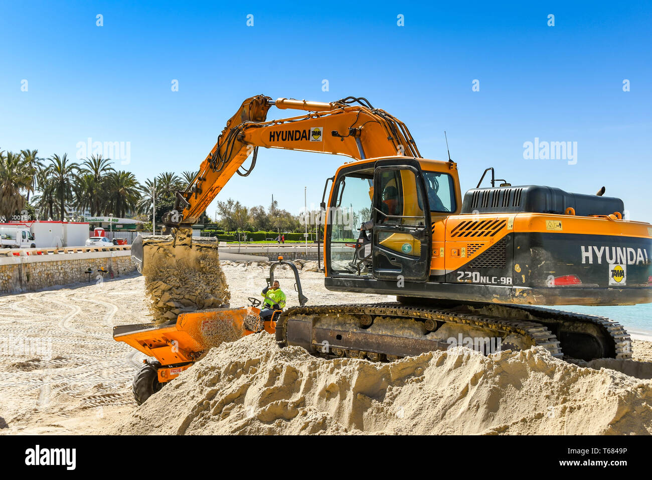 CANNES, Francia - Aprile 2019: Escavatore lavorando su una pila di sabbia viene utilizzato per migliorare la spiaggia di Cannes pronto per l'estate Foto Stock