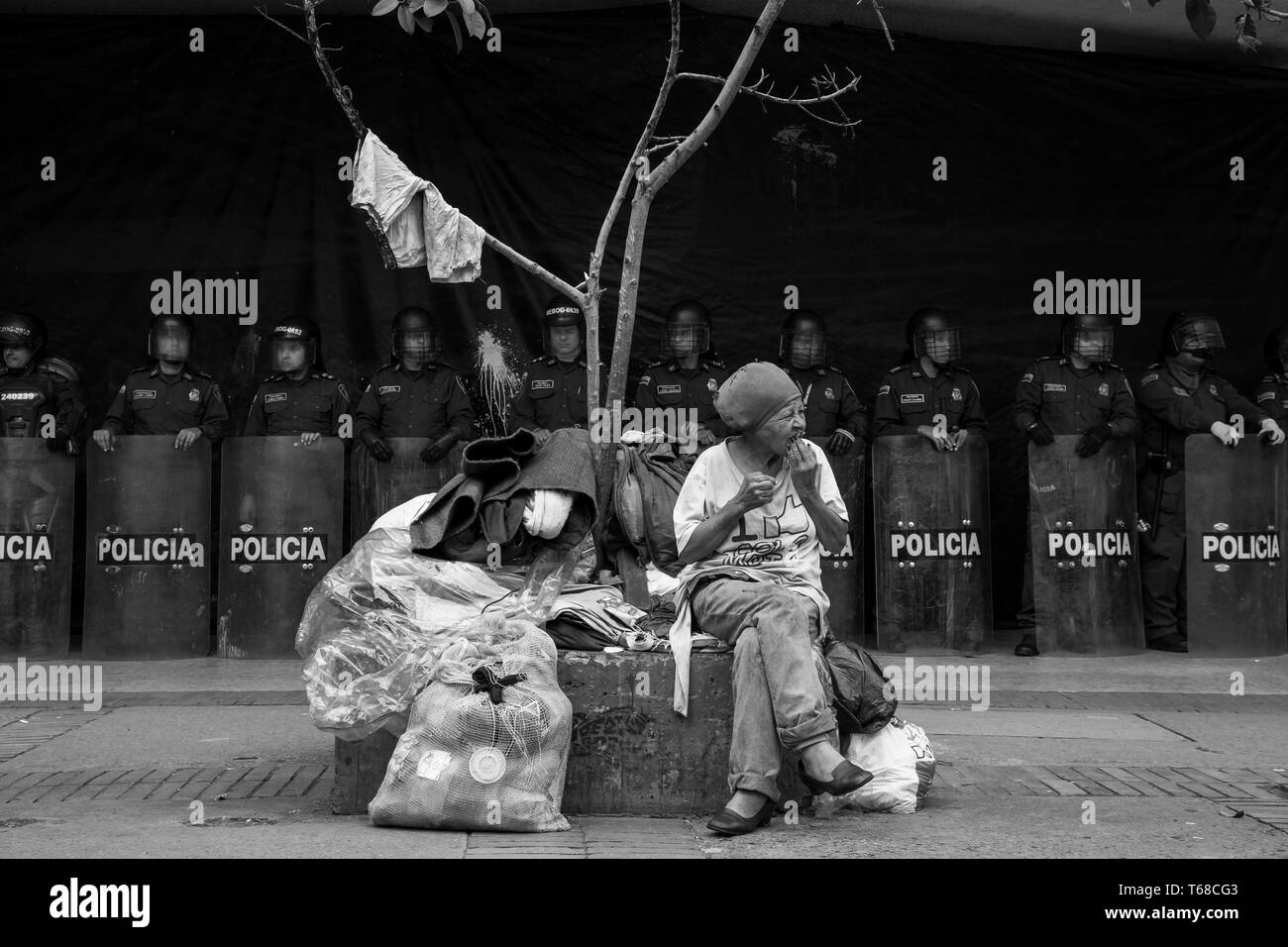 Donna anziana davanti della Polizia antisommossa, Bogotà, Colombia Foto Stock