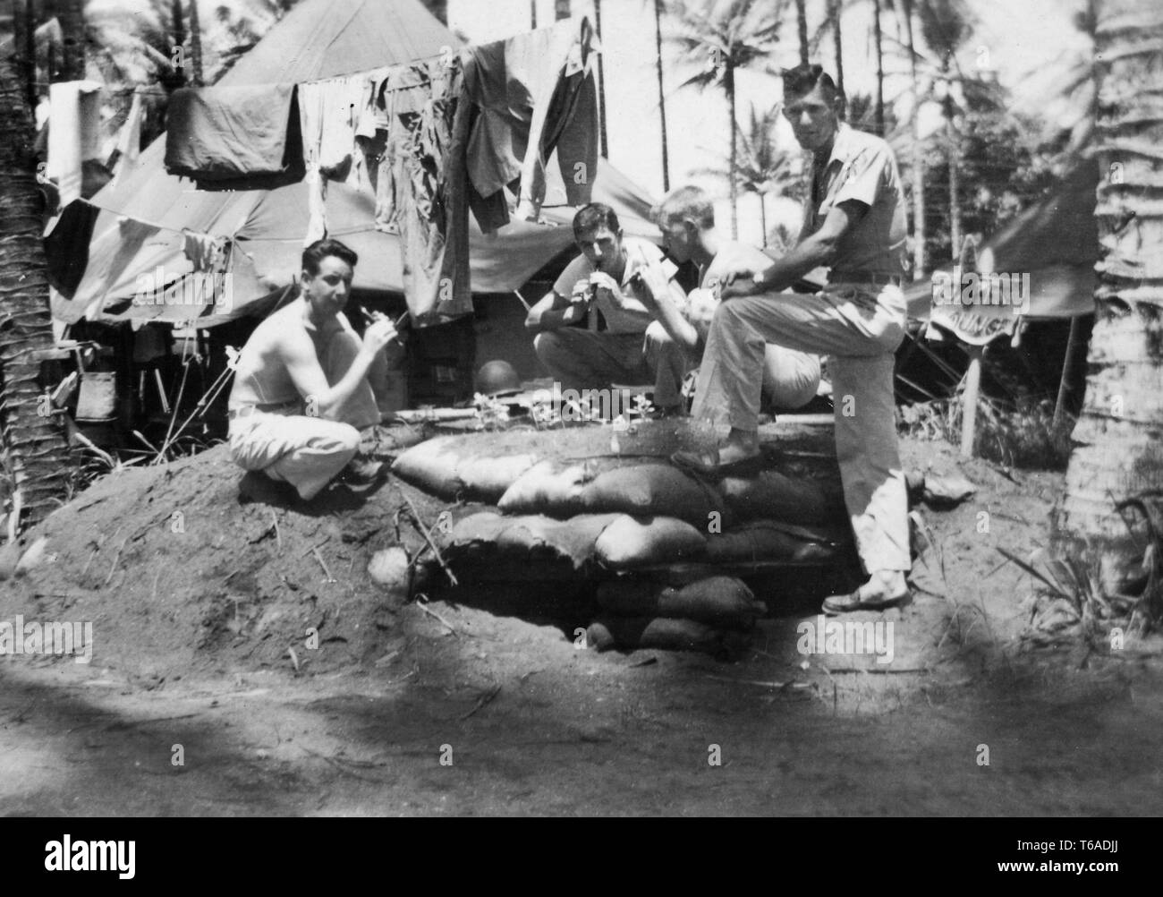 Noi soldati appendere fuori e giocare kazoos registratori o mentre killing time sulla loro base da qualche parte nel Pacifico del Sud durante la II Guerra Mondiale, ca. 1943. Foto Stock