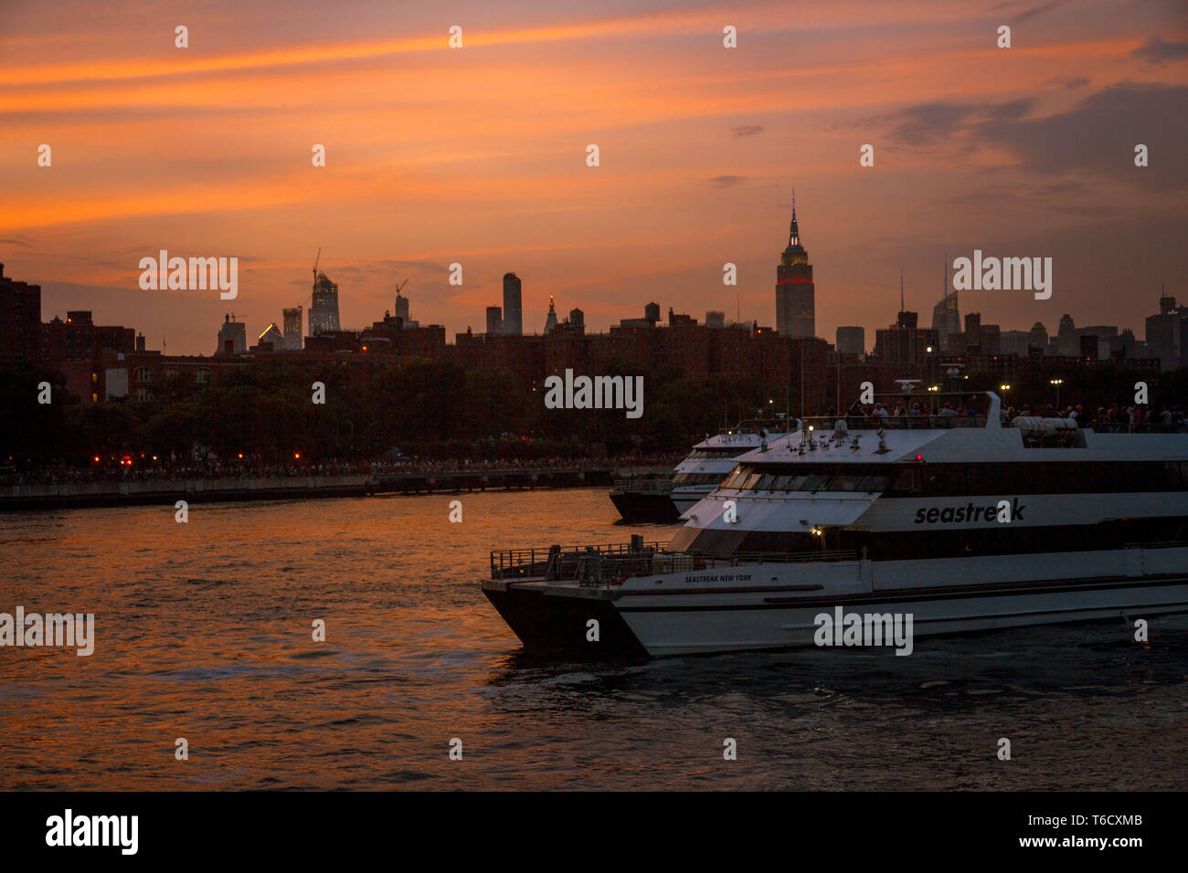 Sonnenuntergang und Boote auf dem East River unter der Brücke am 04.07.2018 zum Unabhängigkeitstag / Tramonto nave su East River sotto il ponte Foto Stock