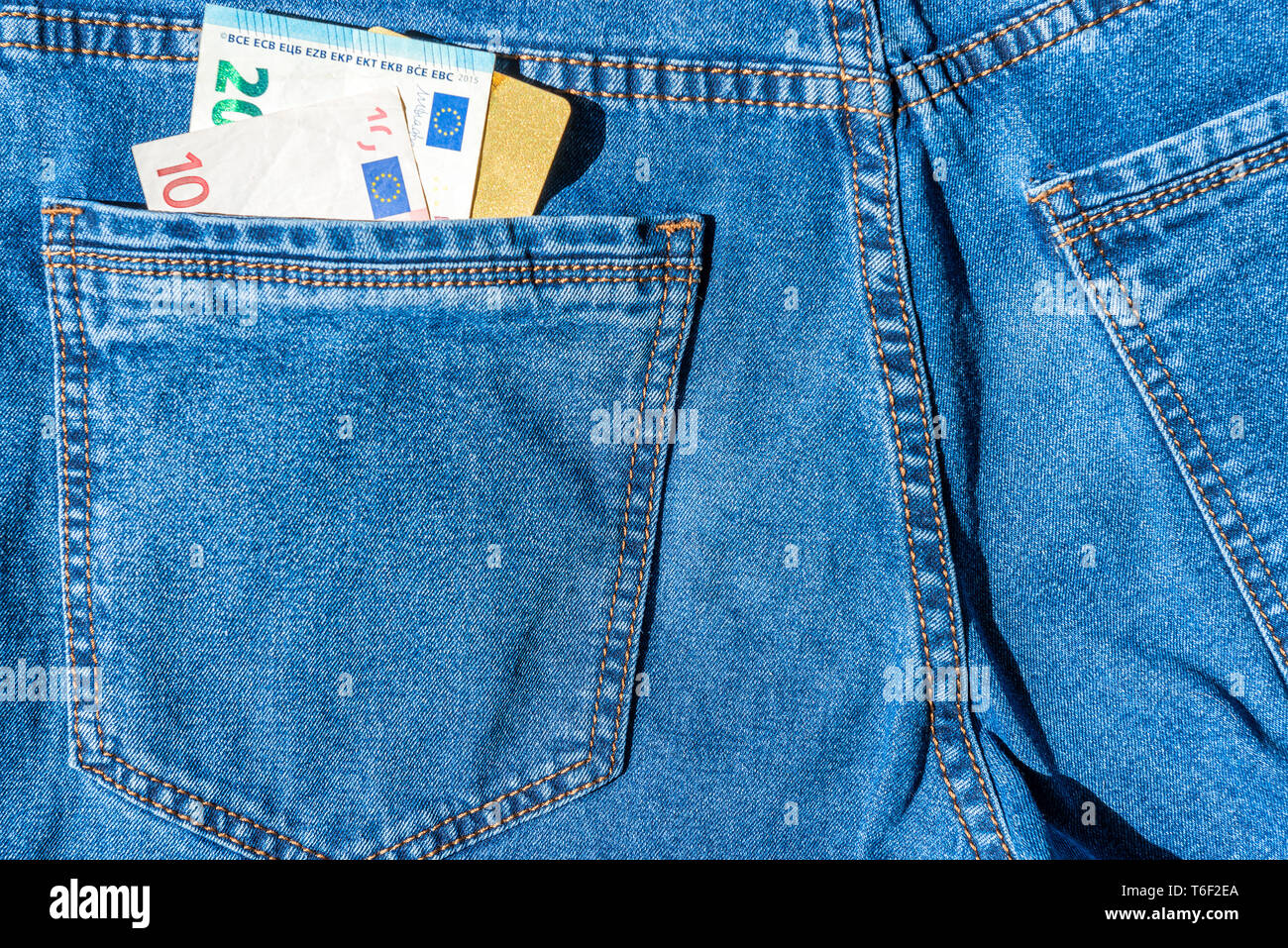Carta di credito Visa con denaro contante in euro in tasca dei jeans Foto Stock