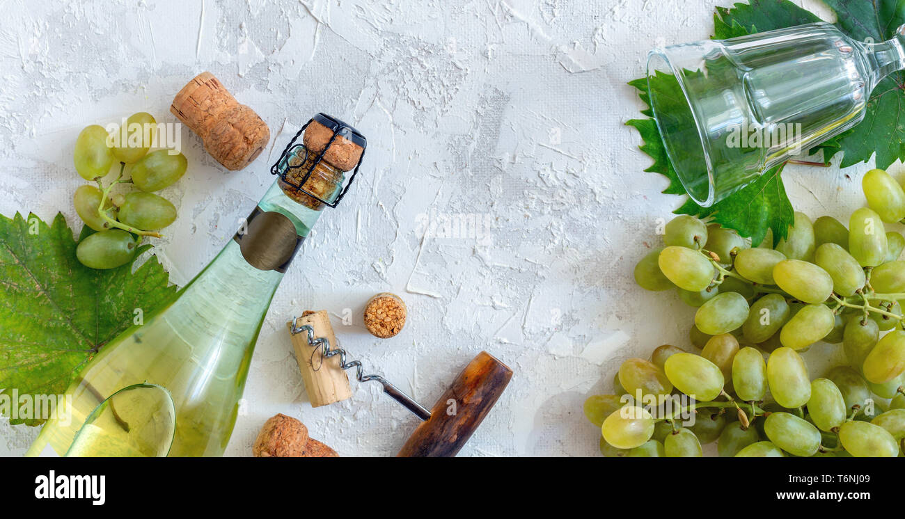 Bottiglia di vino bianco, uva, vetro e un cavatappi. Foto Stock