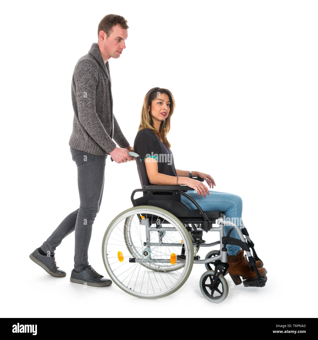 Uomo Donna di spinta in una sedia a rotelle isolati su sfondo bianco Foto Stock