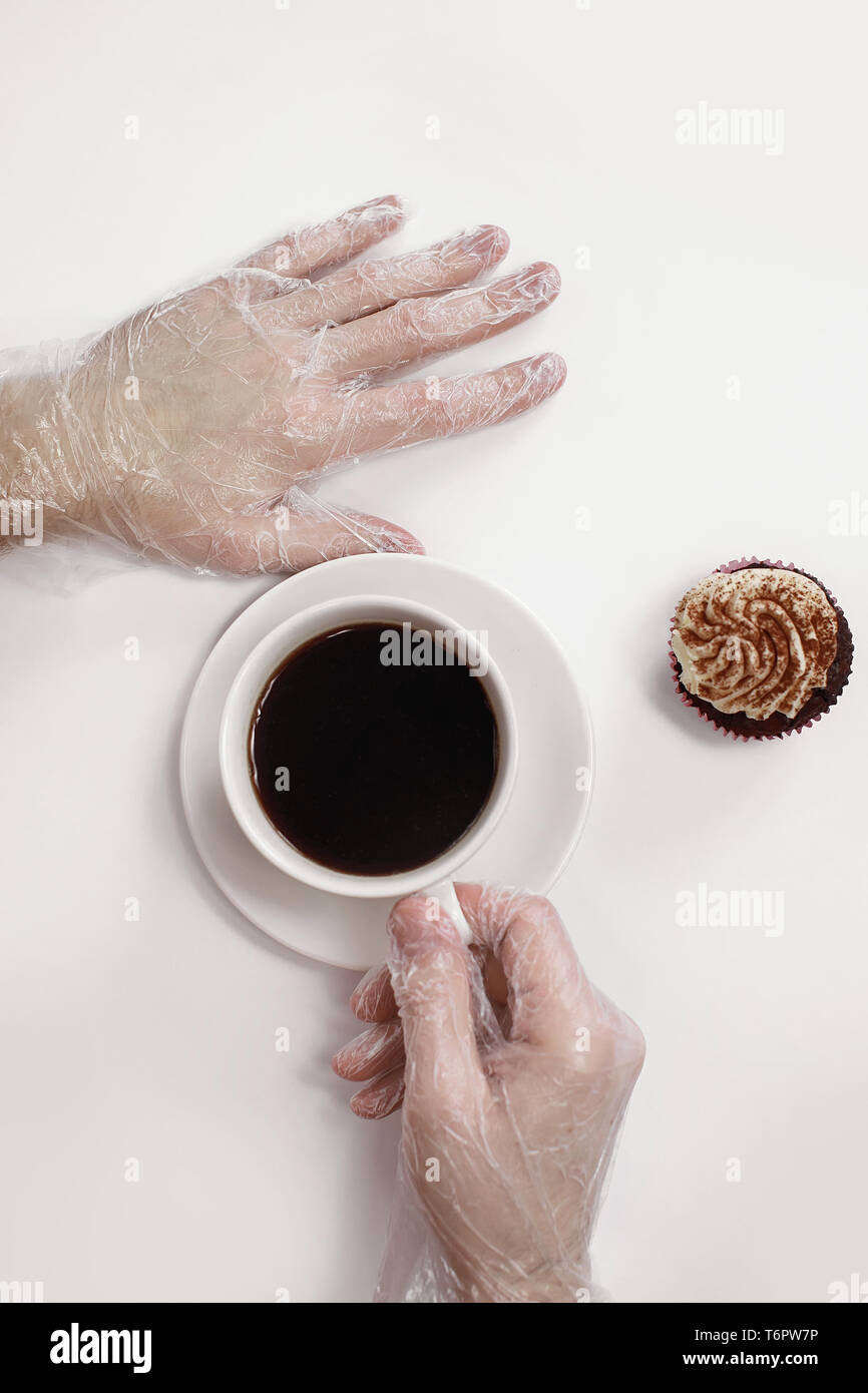 L'uomo ha fatto il massaggio di mani per mezzo di una maschera - un guanto per le mani. Il nutriente, restoring cream. Bel maschio di mani. Attesa con un caffè Foto Stock